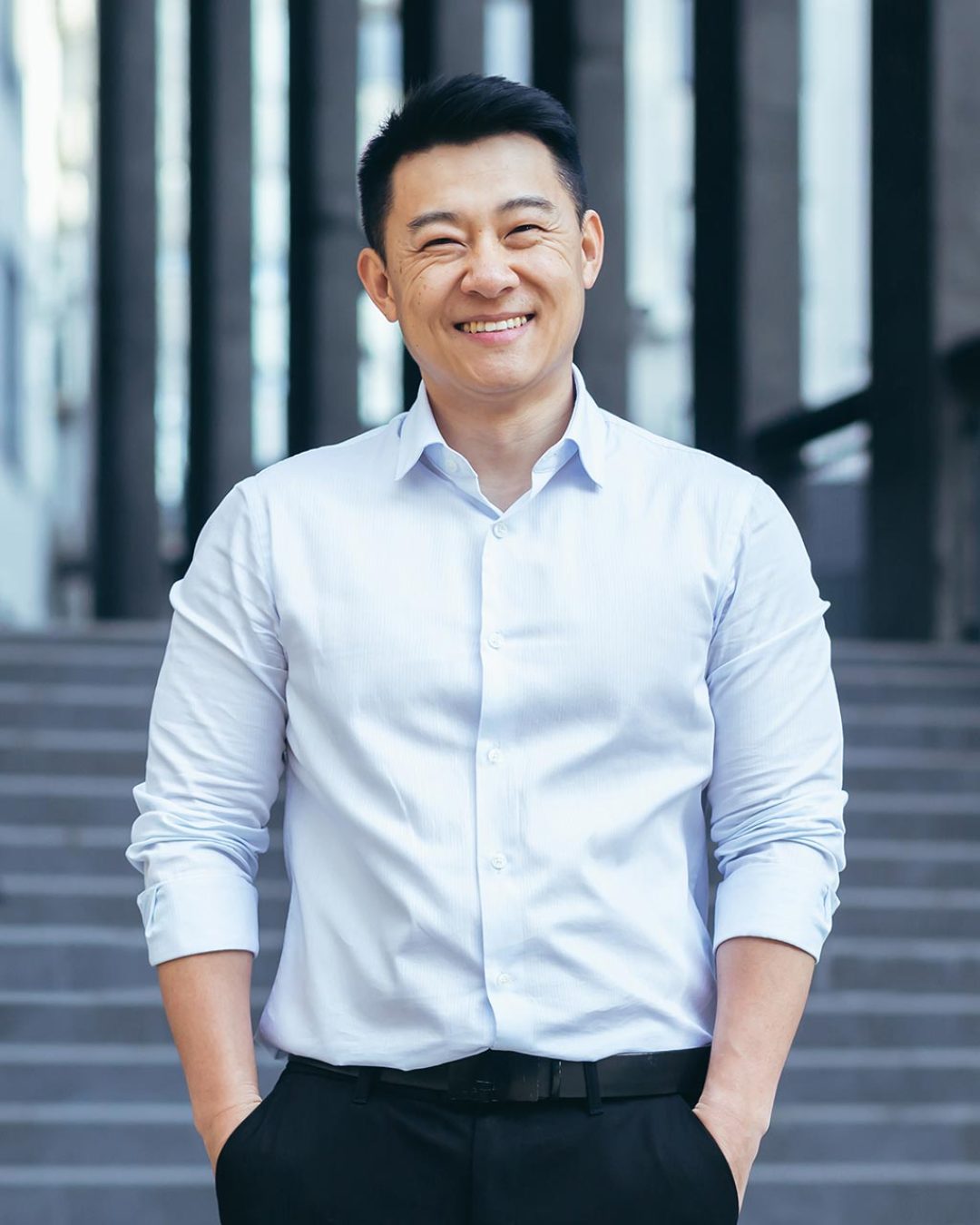 happy-asian-in-shirt-outside-near-office-portrait-2023-11-27-05-21-06-utc.jpg